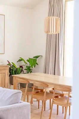 a dining room with a wooden table and chairs at Villa A Grana in Zonza