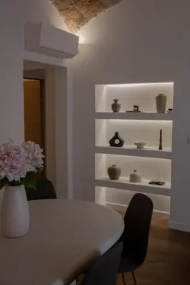 a dining room with a table and a vase with flowers at Liviamariasanta in Ajaccio