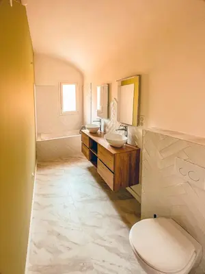 a bathroom with two sinks and a toilet at Liviamariasanta in Ajaccio