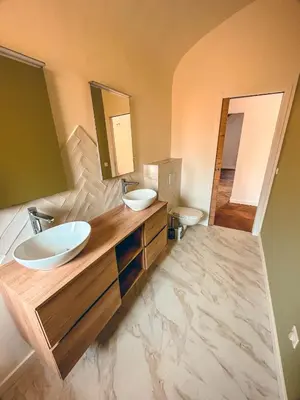 a bathroom with two sinks and two mirrors at Liviamariasanta in Ajaccio