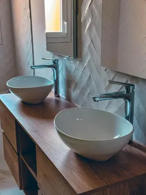 two sinks on a wooden counter in a bathroom at Liviamariasanta in Ajaccio