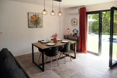 a dining room with a wooden table and chairs at Casa Solana - Piscine privée in Galeria