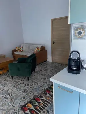 a kitchen with a living room with a couch at Villa in Piedigriggio