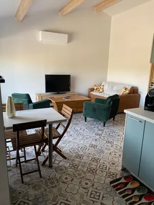 a living room with a table and a couch at Villa in Piedigriggio