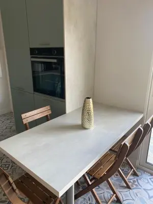 a kitchen table with a vase sitting on top of it at Villa in Piedigriggio