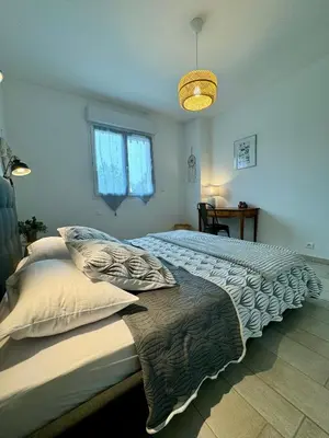 a bedroom with a large bed with pillows on it at Evasion de rêve à Casa Nina in Borgo