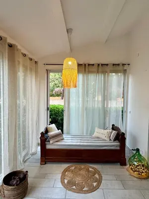 a bedroom with a bed with a large window at Evasion de rêve à Casa Nina in Borgo