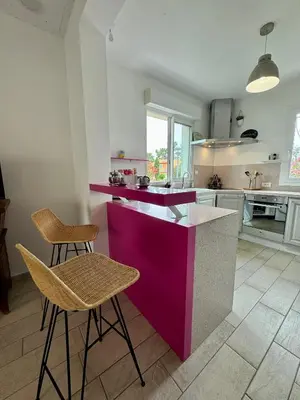 a kitchen with a purple counter and two chairs at Evasion de rêve à Casa Nina in Borgo