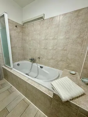 a bathroom with a bath tub in a room at Evasion de rêve à Casa Nina in Borgo
