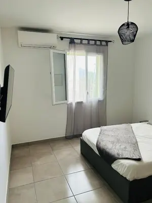 a bedroom with a bed and a window at Appartement T2 Corte in Corte