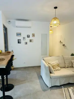 a living room with a couch and a piano at Appartement T2 Corte in Corte