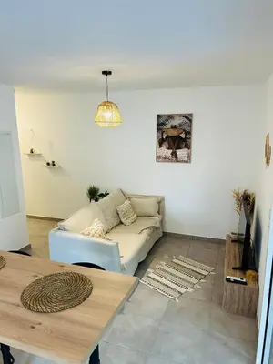 a living room with a couch and a table at Appartement T2 Corte in Corte