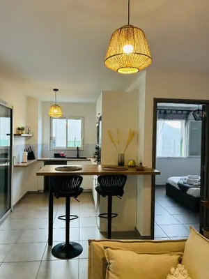 a kitchen and living room with a table and chairs at Appartement T2 Corte in Corte