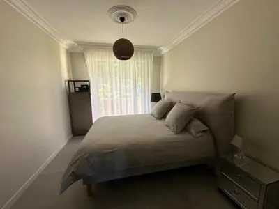 a bedroom with a large bed with a window at Appartement de standing, vue mer, 3 chambres in Ajaccio