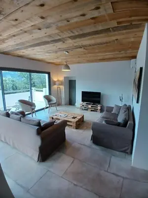 a living room with a couch and a table at Villa Taru Pinarello in Mangialla