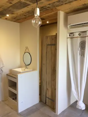 a dressing room with a mirror and a door at Villa Taru Pinarello in Mangialla