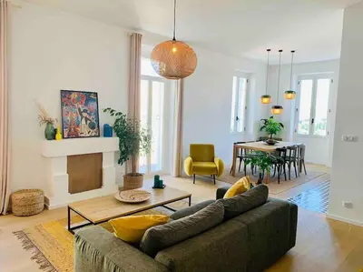 a living room with a couch and a table at Grand logement standing centre ville Porto-Vecchio in Porto-Vecchio