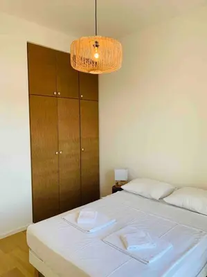 a bedroom with a bed with two towels on it at Grand logement standing centre ville Porto-Vecchio in Porto-Vecchio