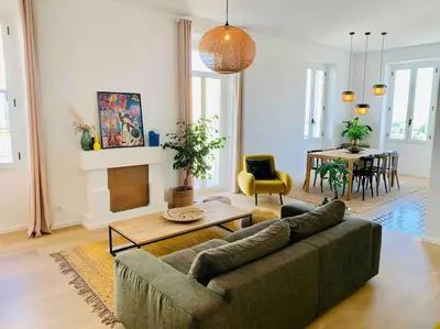 a living room with a couch and a table at Grand logement standing centre ville Porto-Vecchio in Porto-Vecchio