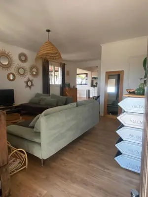 a living room with a green couch in a room at La Carpa in Bonifacio
