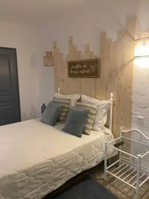 a bedroom with a bed with a sign on the wall at Acquella in Cauro