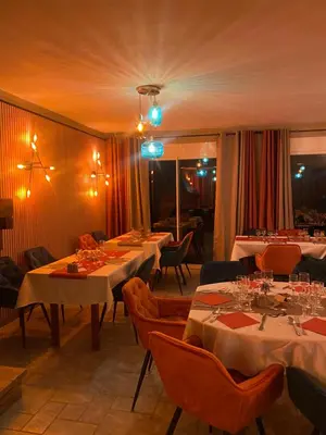 a dining room with tables and chairs and lights at Acquella in Cauro