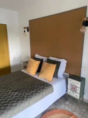 a bedroom with a large bed with yellow pillows at Acquella in Cauro