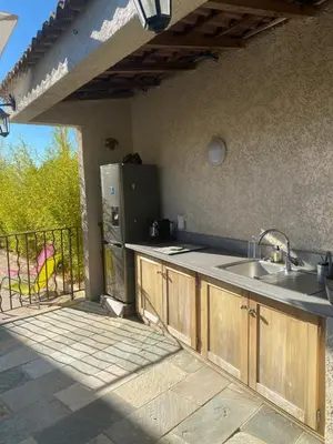 an outdoor kitchen with a sink and a refrigerator at Meacci in Borgo