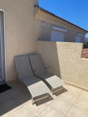 a chair sitting on a patio in front of a building at Meacci in Borgo