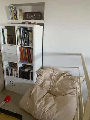 a bedroom with a bed and a book shelf with books at Meacci in Borgo