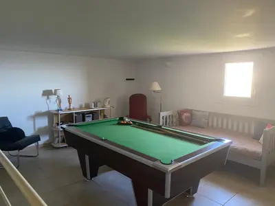 a living room with a pool table and a couch at Meacci in Borgo