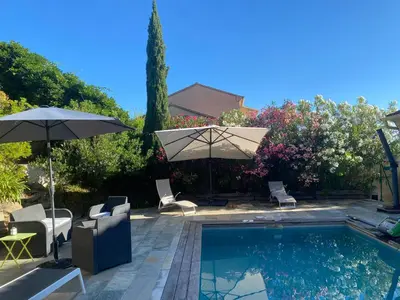 a swimming pool with two umbrellas and chairs next to at Meacci in Borgo