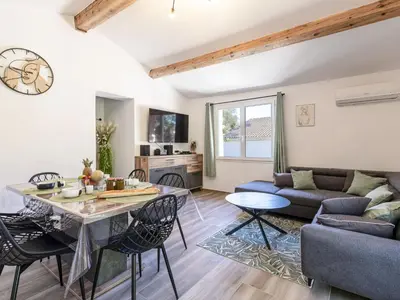 a living room with a couch and a table at Holiday Home Casa Germaine by Interhome in Porto-Vecchio