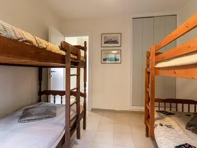 a bedroom with two bunk beds in a room at Holiday Home Agula Marina by Interhome in Moriani Plage