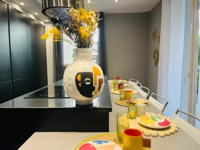 a dining room with a vase with a face on it at Résidence COMAEM in Sarrola-Carcopino