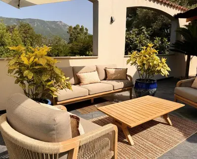 a living room with a couch and a table at Résidence COMAEM in Sarrola-Carcopino