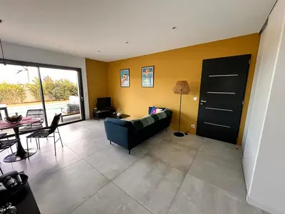 a living room with a couch and a table at Villa KAÏS in Lecci