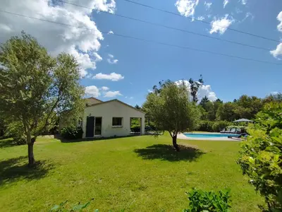 a house with a yard with trees and a pool at Villa Katiris in Porto-Vecchio