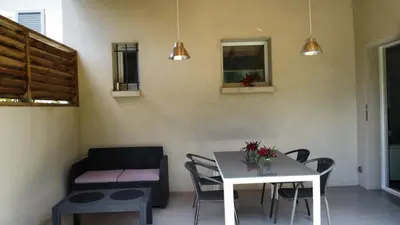 a living room with a table and chairs and a couch at Villa Katiris in Porto-Vecchio