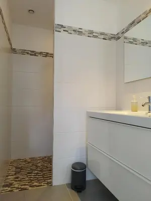 a bathroom with white walls and a sink at Villa Katiris in Porto-Vecchio