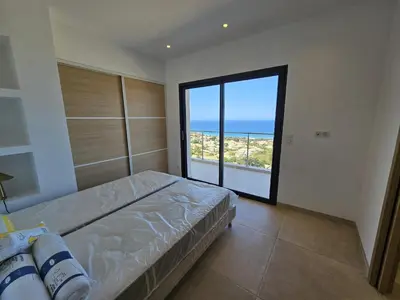 a bedroom with a bed and a view of the ocean at LABELLE- Vue mer panoramique - Piscine privée - Clim -WIFI in Sari Solenzara