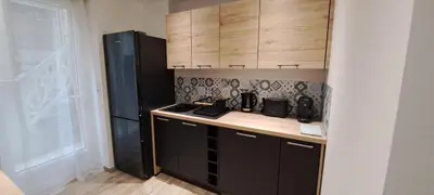 a kitchen with wooden cabinets and a counter top at Charmant studio neuf Ajaccio Casone - Trottel in Ajaccio
