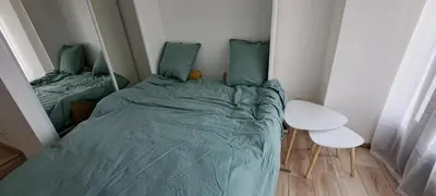 a small bedroom with a bed and a table at Charmant studio neuf Ajaccio Casone - Trottel in Ajaccio