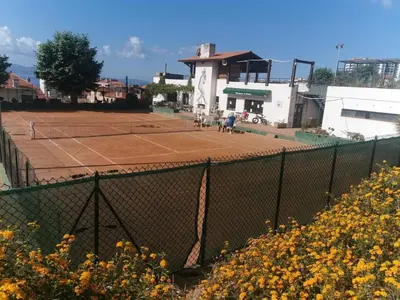 a tennis court with two people playing tennis on it at Charmant studio neuf Ajaccio Casone - Trottel in Ajaccio
