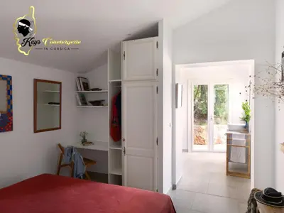 a bedroom with a door leading into a room at Villa Ficaja 10 pers JACUZZI vue MER PINARELLO in Zonza