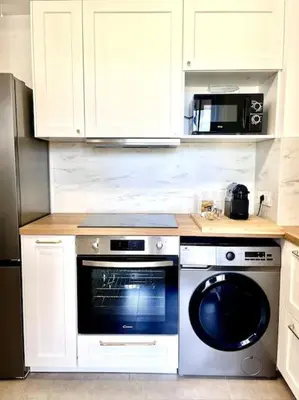 a kitchen with a stove and a dishwasher at Appartement neuf centre-ville in Porto-Vecchio