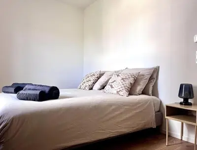 a bedroom with a bed with pillows on it at Appartement neuf centre-ville in Porto-Vecchio
