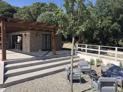 a patio with two chairs and a pavilion at Appartement dernier étage avec spa privatif sur grande terrasse in Porto-Vecchio