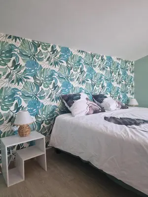 a bedroom with a bed with a blue and green wall at Maison pour 4 personnes en bord de mer in Borgo