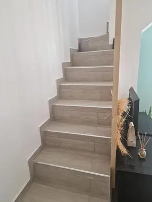 a staircase in a room with a wooden floor at Maison pour 4 personnes en bord de mer in Borgo